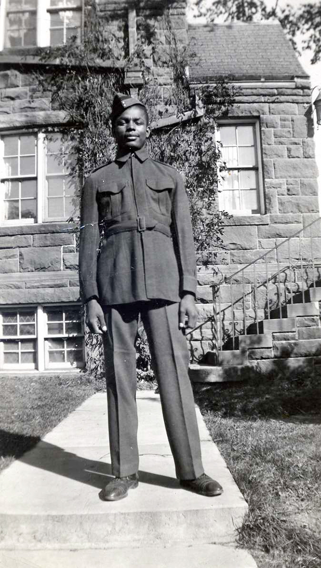 Danny Gray standing outside Mount Allison's Palmer Hall in his cadet uniform in 1947. 